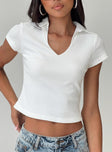 Front view of model wearing  front Princess Polly Short Sleeves Scoop Neck  Amorette Polo Top White