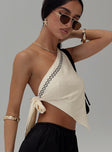 side view of model wearing Princess Polly Frankle Top Cream/black Sleeveless Asymmetric Neckline 