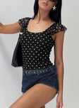 front view of model wearing Princess Polly Beckinsale Polka Top Black Short Sleeves Scoop Neck 