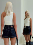 back view of model wearing Princess Polly Heuston Denim Skort Dark Wash High Waisted Shorts 