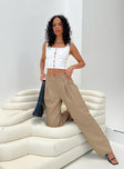 Front view of model wearing  front Princess Polly High Waisted Pants  Caley Asymmetric Waistband Pants Beige