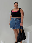 side view of model wearing Princess Polly Gazelle Denim Skort Mid Wash Curve High Waisted Shorts 