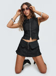 front view of model wearing Princess Polly Isibel Skort Black Low Rise Shorts 