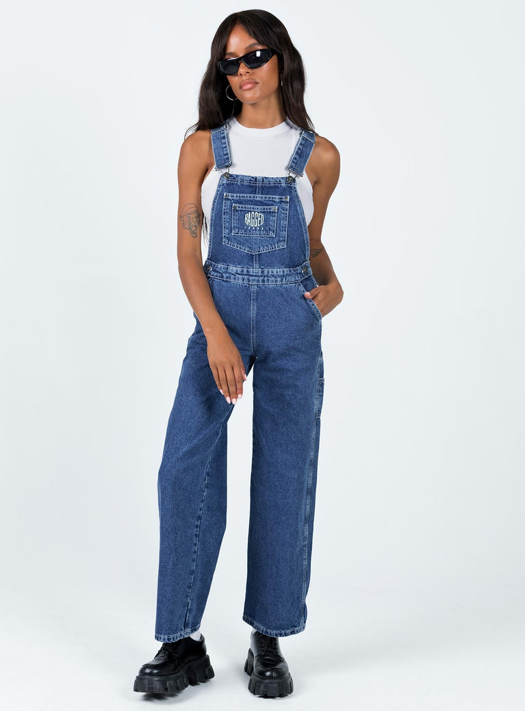 Overalls Mid wash denim  Embroidered graphic at chest  Adjustable shoulder straps Chest & leg pockets Four classic pockets  Button fastening at hips Wide leg 