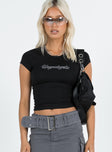 Front view of model wearing  front Princess Polly Short Sleeves Crew Neck  Unapologetic Tee Black