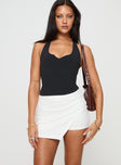 front view of model wearing Princess Polly Maceline Wrap Front Skort White High Waisted Shorts 