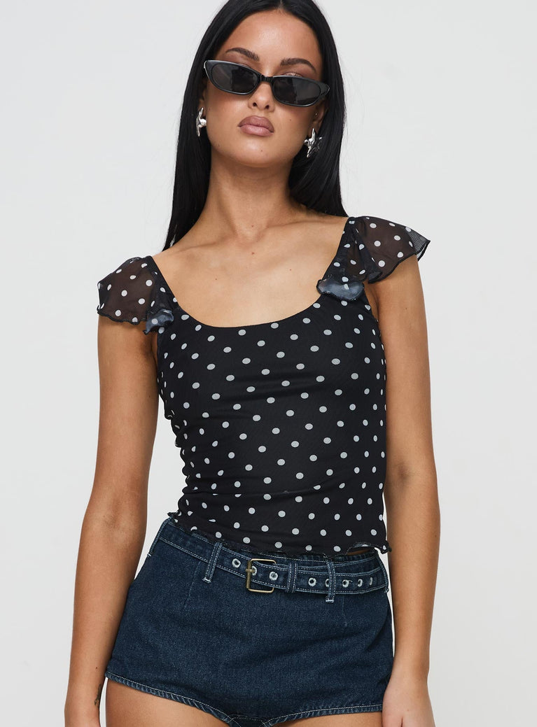 front view of model wearing Princess Polly Beckinsale Polka Top Black Short Sleeves Scoop Neck 