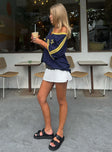 side view of model wearing Princess Polly Gigi Skort White High Waisted Shorts 