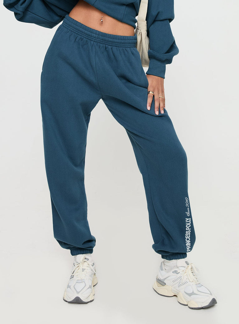 side view of model wearing Princess Polly Princess Polly Track Pants Block / Cursive Text Slate Mid Rise 