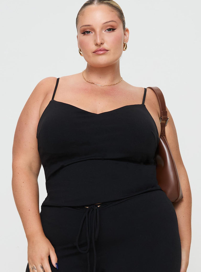 side view of model wearing Princess Polly Evanda Top Black Curve Sleeveless V-Neck 