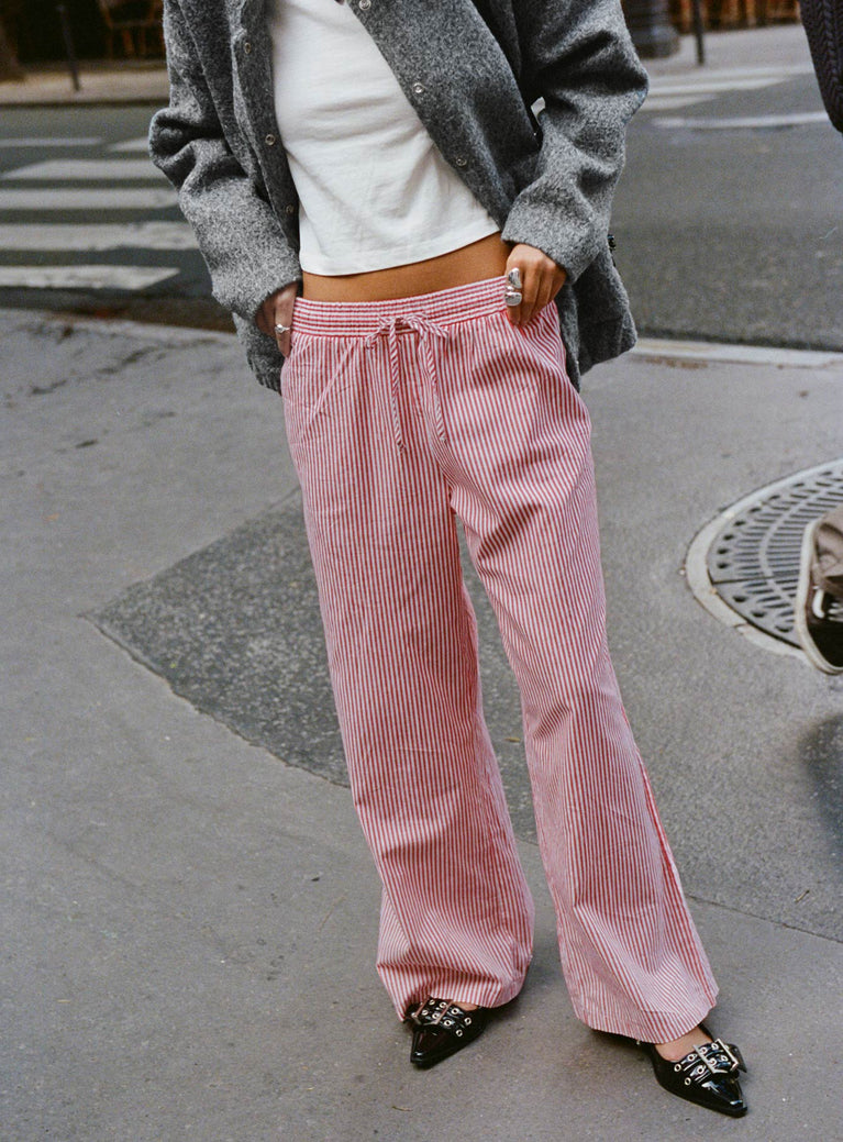 side view of model wearing Princess Polly Holiday Tie Front Pants Red/White Stripe Low Rise Pants 