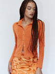 side view of model wearing Princess Polly Elody Long Sleeve Top Orange 