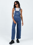 Overalls Mid wash denim  Embroidered graphic at chest  Adjustable shoulder straps Chest & leg pockets Four classic pockets  Button fastening at hips Wide leg 