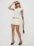 front view of model wearing Princess Polly Deei Double Ruffle Mini Skort Soft Lemon Low Rise Shorts 