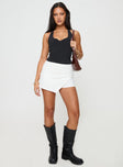 front view of model wearing Princess Polly Maceline Wrap Front Skort White High Waisted Shorts 