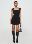 side view of model wearing Princess Polly Ravenna Mini Dress Black Scoop Neck 