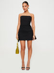 side view of model wearing Princess Polly Bradwell Strapless Mini Dress Black Petite Straight Neck 