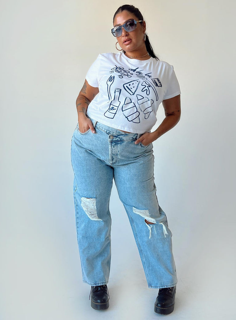 Front view of model wearing  front Princess Polly Low Rise Jeans  Holly Asymmetric Ripped Leg Jeans Curve