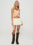 front view of model wearing Princess Polly Niklaus Top Cream Floral Sleeveless V-Neck 