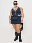   side view of model wearing Princess Polly Popular Low Rise Mini Skirt Mid Blue Wash Curve Mini Skirts 