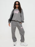 side view of model wearing Princess Polly Princess Polly Track Pants Puff Text Charcoal 