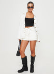 front view of model wearing Princess Polly Katlynne Denim Mini Skort White mid-rise 