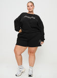 front view of model wearing Princess Polly Princess Polly Track Shorts Cursive Text Black Sand Curve High Waisted Shorts 