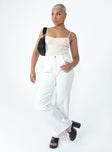 Front view of model wearing  front Princess Polly Mid Rise  Arlington Straight Leg Denim Jeans White