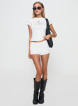 front view of model wearing Princess Polly Femme Micro Short White Low Rise Shorts 