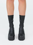 Boots  Faux leather material  Fitted at leg  Block heel  Platform base  Square toe  Slight stretch 