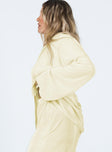 side view of model wearing Princess Polly Taina Pleated Shirt Cream Full Sleeves V-Neck 