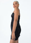 side view of model wearing Princess Polly Snowbird Mini Dress Black Sweetheart Neckline 