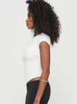 side view of model wearing Princess Polly Evienne Top White Short Sleeves Asymmetric Neckline 