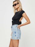 side view of model wearing Princess Polly Gazelle Denim Skort Light Wash Lower Impact High Waisted Shorts 