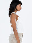 side view of model wearing Princess Polly Brearley Top White Sleeveless Plunger 