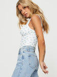 side view of model wearing Princess Polly Lupton Bodysuit White / Blue Floral Sleeveless 