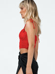 side view of model wearing Princess Polly Stephano Top Red 