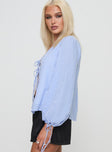 side view of model wearing Princess Polly Slide Away Top Blue Full Sleeves V-Neck 