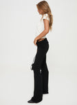 side view of model wearing Princess Polly Ruffled Up Flare Pants Black High Waisted Pants High Waisted Pants High Waisted Pants 