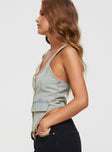 side view of model wearing Princess Polly Nyc Denim Halter Top Light Wash Sleeveless Scoop Neck 