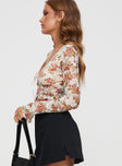 side view of model wearing Princess Polly Amessa Long Sleeve Top Floral Full Sleeves Plunger 