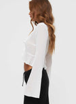 side view of model wearing Princess Polly Gylda Long Sleeve Top White Full Sleeves Plunger 