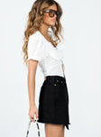   side view of model wearing Princess Polly Banksia Denim Mini Skirt Black Mini Skirts 