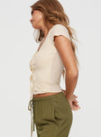 side view of model wearing Princess Polly Fincher Lace Up Top Cream Short Sleeves Scoop Neck 