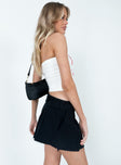 back view of model wearing Princess Polly Elle Mini Skirt Black Mini Skirts 