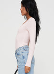 side view of model wearing Princess Polly Delgado Long Sleeve Bodysuit Pink Full Sleeves 