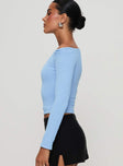 side view of model wearing Princess Polly Malian Long Sleeve Top Blue Full Sleeves Asymmetric Neckline 