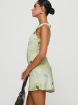 side view of model wearing Princess Polly Vivre Mini Dress Green Floral Crew Neck 