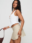   side view of model wearing Princess Polly Dapple Bias Mini Skirt Beige Mini Skirts 