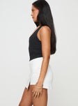 side view of model wearing Princess Polly Maceline Wrap Front Skort White High Waisted Shorts 